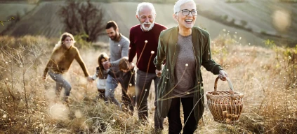 A model house with red roof and coins piled close by