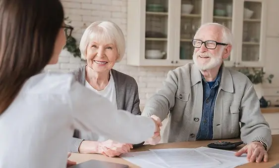 Grandparents signing a contract