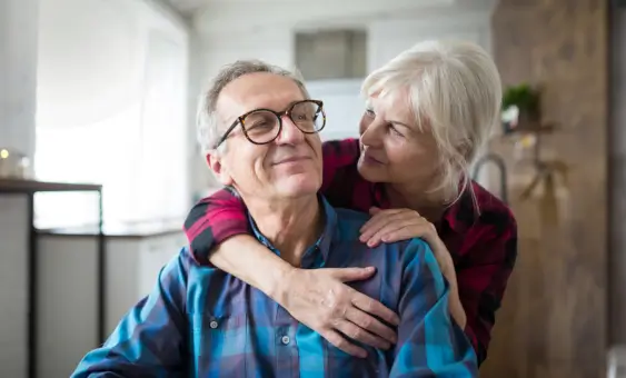 Couple with arms around each other
