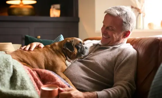 Man with dog on sofa