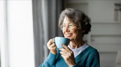Lady with cup holding a hot drink in a cup