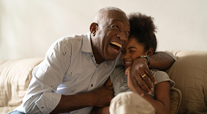 Man cuddling with grandchild